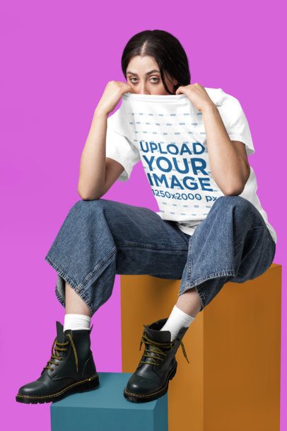 Comfort Colors T-Shirt Mockup of a Woman Sitting on a Colorful Cube in a Studio m57430