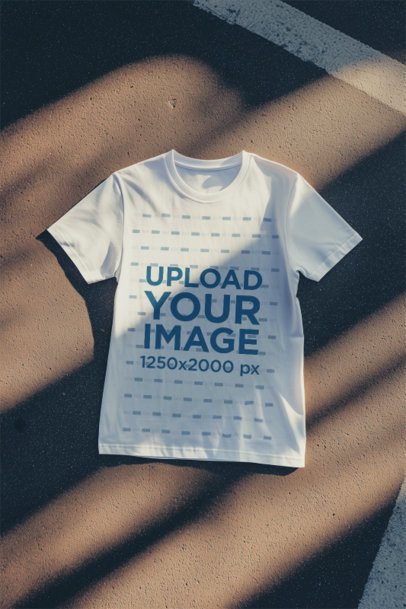 Mockup of an AI-Generated T-Shirt Lying on the Pavement m54327