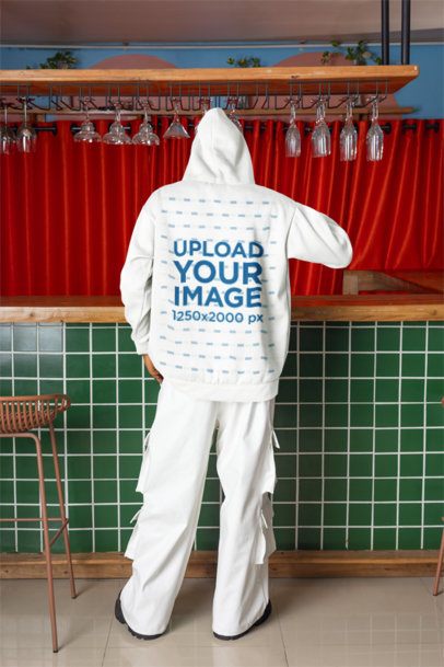 Back-View Mockup of a Man Wearing a Pullover Hoodie in a Bar