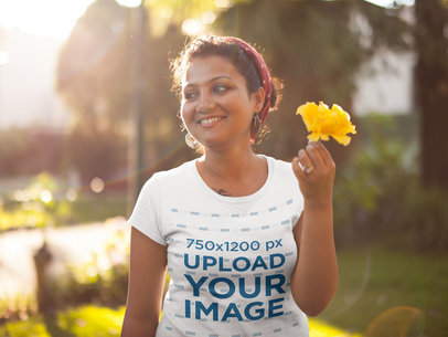 T-Shirt Mockup of a Beautiful Woman Holding a Yellow Flower