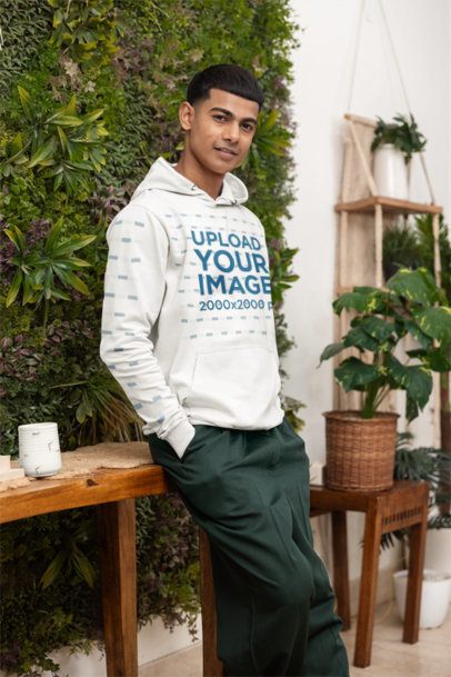 Hoodie Mockup of a Happy Man Posing Against a Living Wall in a Cozy Setting m55433