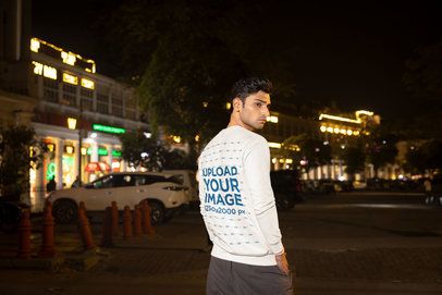 Sweatshirt Mockup Featuring a Man Posing in the Street With a Serious Look m56863
