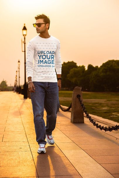 Bella Canvas Long-Sleeve Tee Mockup Featuring a Man Walking in a Street With a Nice Sunset View m56793