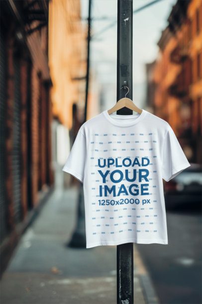 AI-Created Mockup Featuring a Round-Neck T-Shirt Placed on a Wooden Hanger in the Street m54330