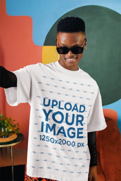 Oversized T-Shirt Mockup of a Man Taking a Selfie and Posing With a Flirty Look m57293
