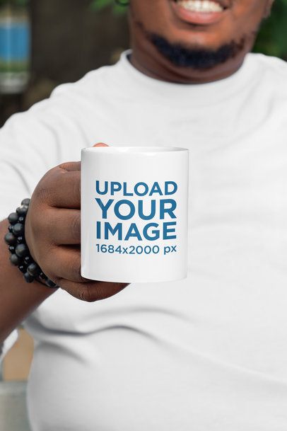 Mockup of a Happy Cropped-Face Bearded Man Showing a Coffee Mug
