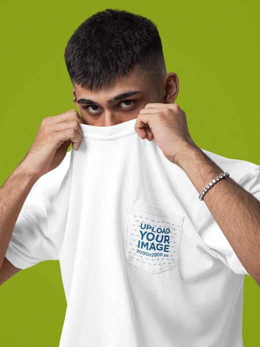 Comfort Colors Pocket Tee Mockup of a Man Covering Half His Face in a Studio Setting