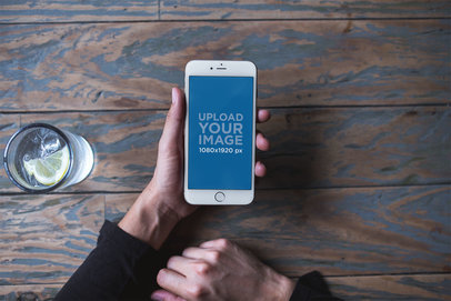 Mockup of a Silver iPhone 8 Plus Being Held Next to a Glass of Lime Water a21599