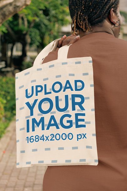 Mockup of a Man With a Loc Hairstyle Carrying a Tote Bag on His Back in a Park