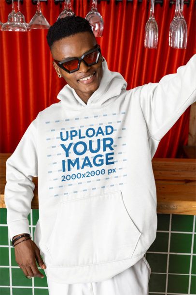 Pullover Hoodie Mockup of a Smiling Man Taking a Selfie in a Bar