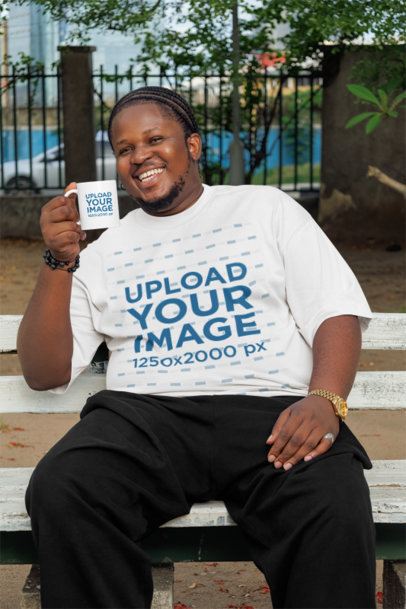 Oversized T-Shirt Mockup Featuring a Bearded Man Sitting on a Bench While Holding a Coffee Mug