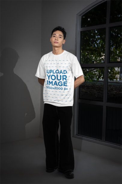 Oversized Crewneck Tee Mockup Featuring a Man Standing Next to a Window m54147