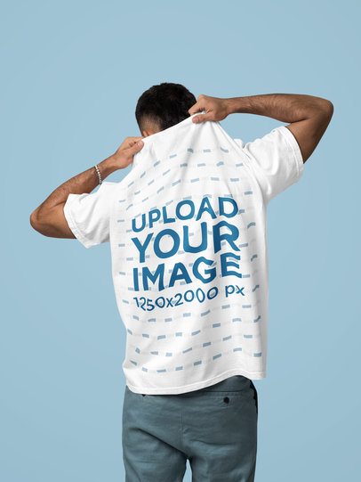 Back-View Mockup Featuring a Man Taking Off His Comfort Colors T-Shirt in a Studio m57435