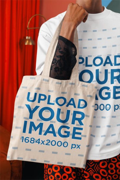 Oversized T-Shirt Mockup of a Cropped-Face Man Holding a Sublimated Tote Bag m57308