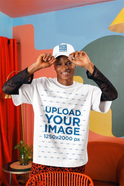Oversized T-Shirt Mockup Featuring a Smiling Man Putting on His Dad Hat in a Living Room