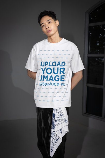 Oversized T-Shirt Mockup of a Serious Man Posing Near a Window m54178