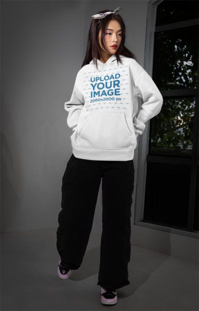 Hoodie Mockup Featuring an Alternative-Styled Woman Posing Next to a Window m54167