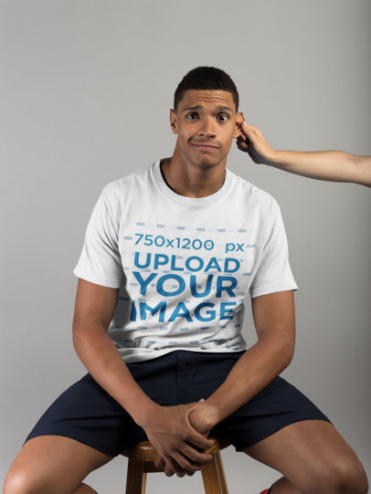 T-Shirt Mockup of a Man Having his Ear Pulled