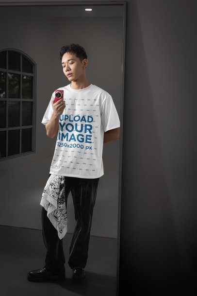 Oversized T-Shirt Mockup of a Serious Man Taking a Picture in a Mirror m54173