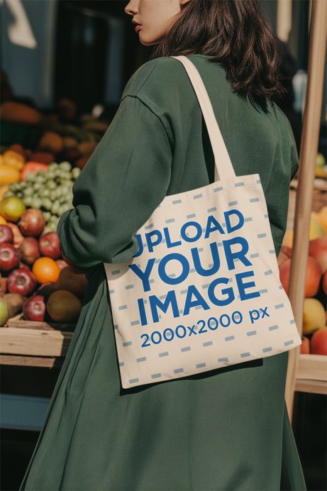Tote Bag Mockup Featuring an AI-Created Cropped-Face Woman Walking in a Food Market