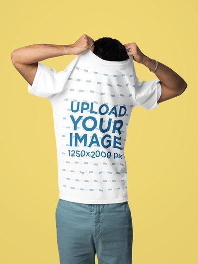 Comfort Colors Mockup Featuring a Man Taking Off His T-Shirt in a Studio m57433