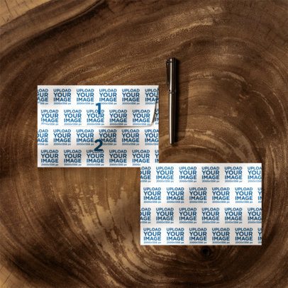 Postcard and Envelope Mockup Featuring a Wooden Background and a Pen