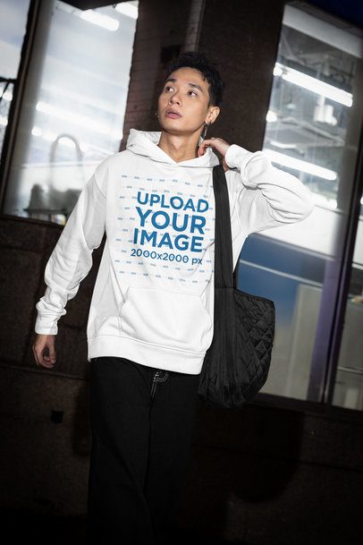 Pullover Hoodie Mockup Featuring an Alternative-Styled Man Walking by the Street m54208