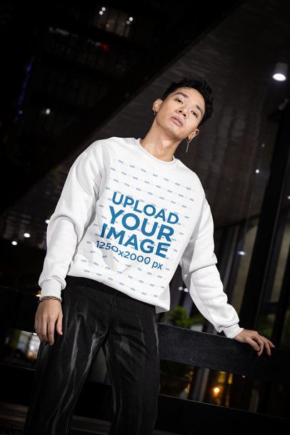 Sweatshirt Mockup Featuring a Serious Man Posing in the Street at Night m54201