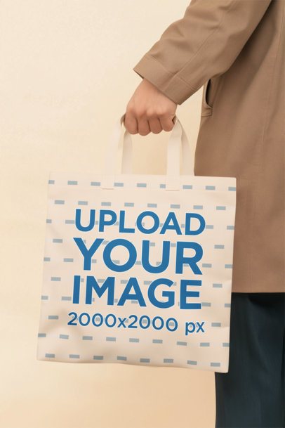 AI-Created Mockup Featuring a Person Holding a Sublimated Tote Bag in a Studio m55082