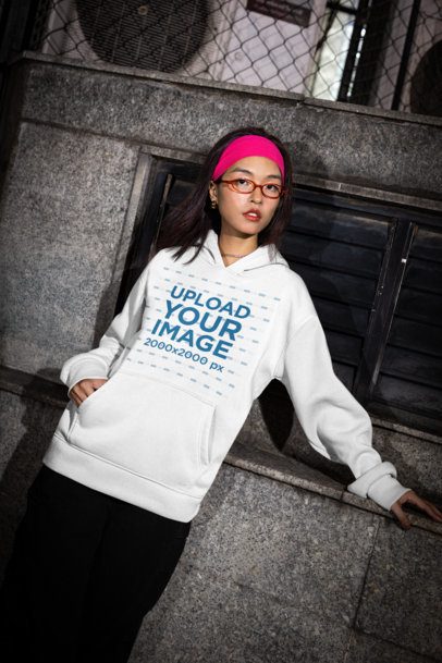 Pullover Hoodie Mockup Featuring a Woman Posing in the Street With an Alternative Outfit m54206