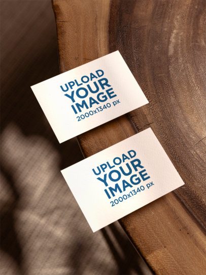 Mockup Featuring Two Business Cards Lying on a Wooden Surface