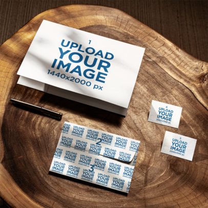 Folder Mockup Featuring an Envelope and Two Business Cards Lying on a Wooden Surface