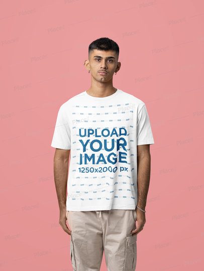Oversized T-Shirt Mockup Featuring a Serious Man Standing in a Colorful Studio Setting m57442