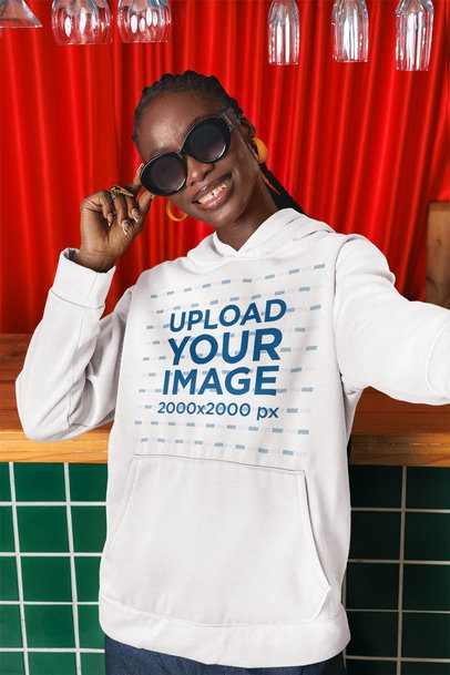 Pullover Hoodie Mockup of a Happy Woman Taking a Selfie in a Bar