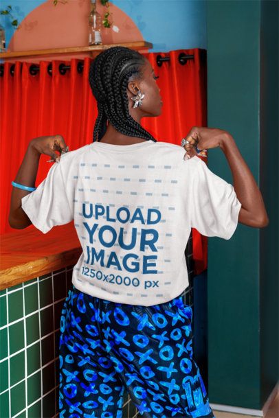Back-View Mockup of a Woman Grabbing Her T-Shirt in a Bar