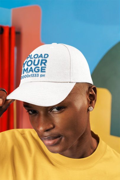 Dad Hat Mockup Featuring a Man With a Piercing Posing in a Colorful Living Room
