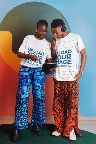 T-Shirt Mockup of a Cheerful Woman Showing a Tablet to a Surprised Man