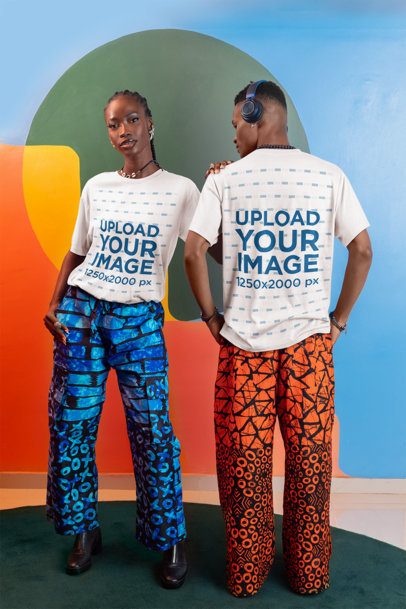 Round-Neck Tee Mockup Featuring a Serious Woman Posing Next to a Man Against an Artsy Wall