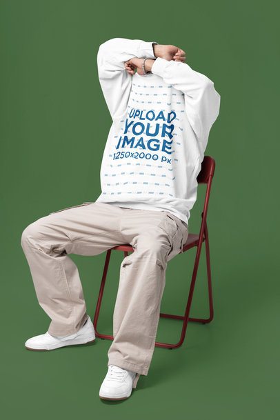 Comfort Colors Mockup Featuring a Man Taking Off His Sweatshirt While Sitting on a Chair m57427