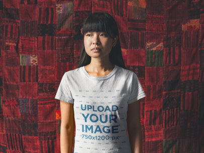 T-Shirt Mockup Featuring an Asian Girl Standing Against a Big Red Cloth 20566