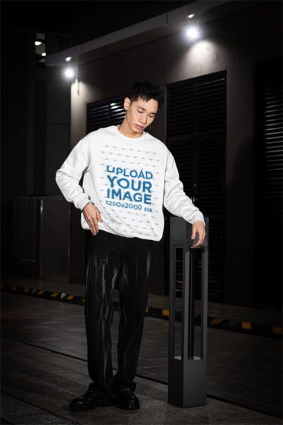 Alternative-Styled Mockup Featuring a Man Posing With a Crewneck Sweatshirt in the Street m54199