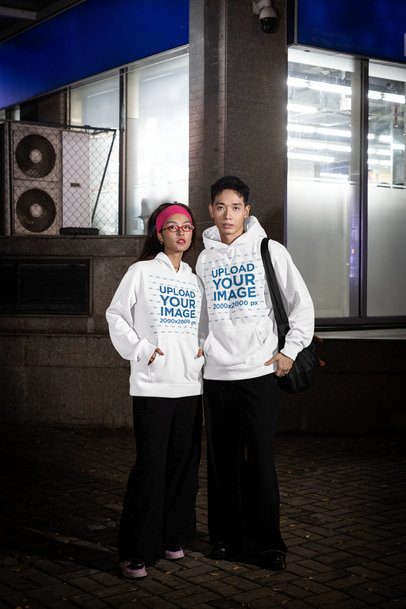 Alternative-Styled Mockup Featuring a Couple Wearing Pullover Hoodies in the Street m54205
