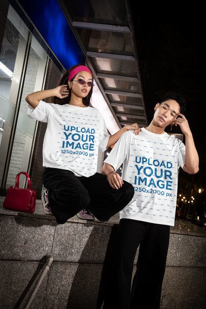 Oversized T-Shirt Mockup Featuring a Man and a Woman Posing on the Sidewalk m54210