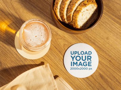 Mockup of a Coaster Placed on a Table With Beer and Bread m58061