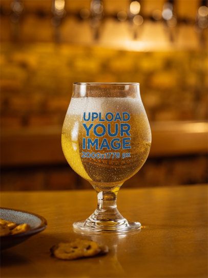 Mockup of a Tulip Glass Filled With Beer Placed on a Bar Counter m58058