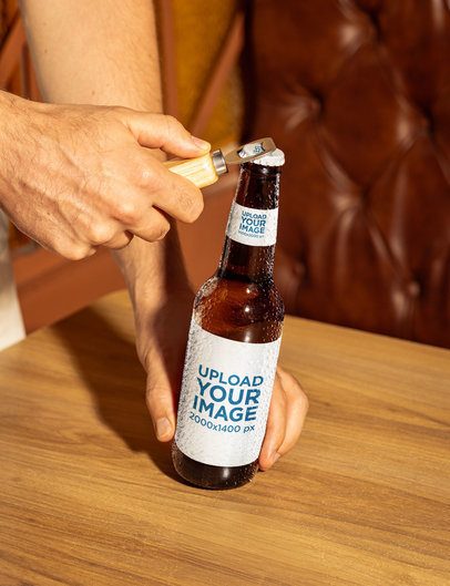 Mockup of a Man Opening an Ambar Beer Bottle in a Restaurant m58069