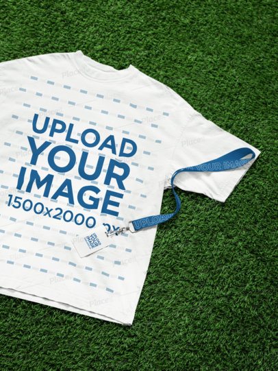 Oversized T-Shirt Mockup Featuring a Lanyard With a Badge Holder Lying on the Grass m58156