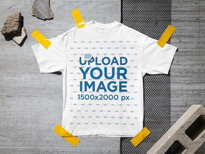 Mockup of an Oversized T-Shirt and a Pin Lying on an Urban Street Floor m58165