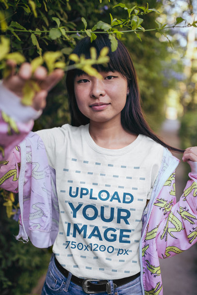 T-Shirt Mockup of a Woman Wearing a Pink Jacket with Yellow Crocodiles 20569
