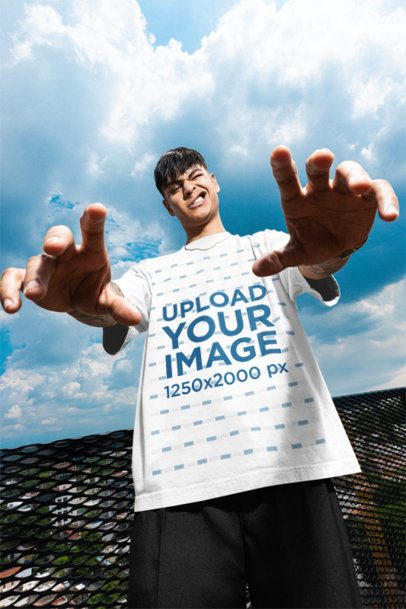 Oversized T-Shirt Mockup of a Man Trying to Do a Frame Pose on a Rooftop m57621